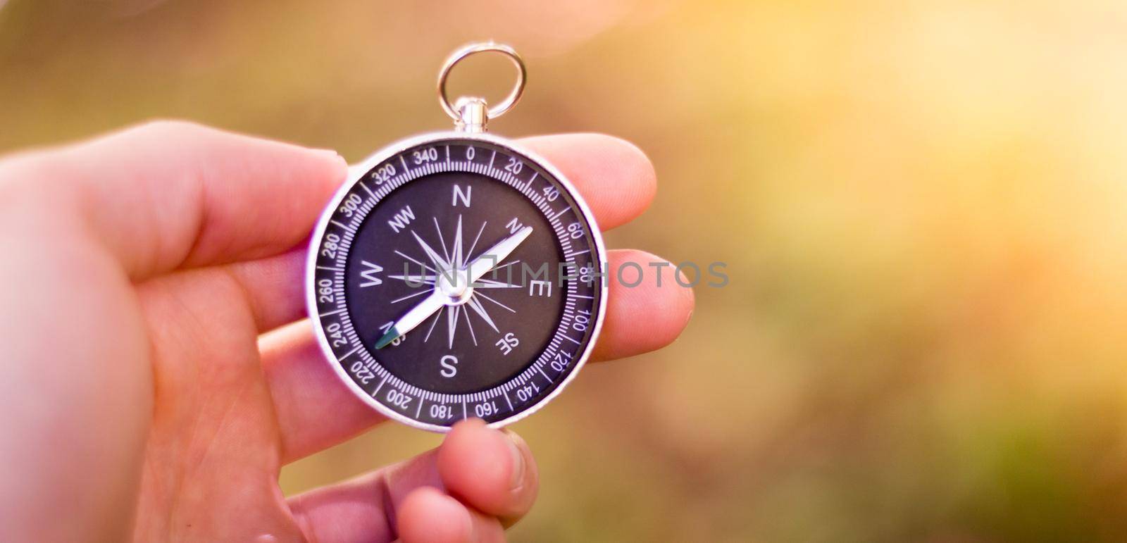 Adventure: Compass in man’s hand, showing the direction by Daxenbichler
