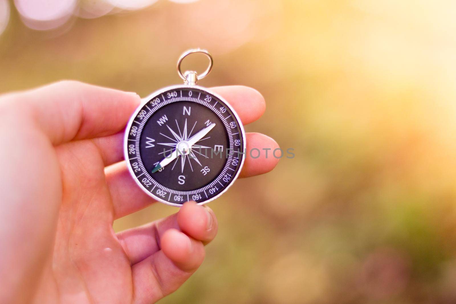 Vintage compass in man’s hand, adventure and discovery concept