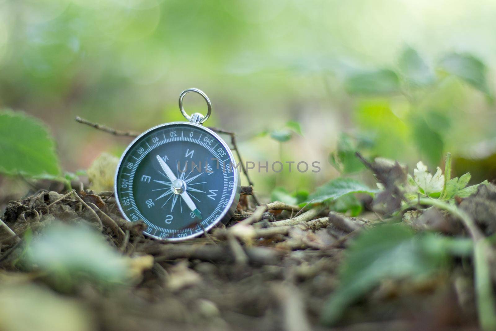 Vintage compass lying on the floor. Adventure and discovery concept.