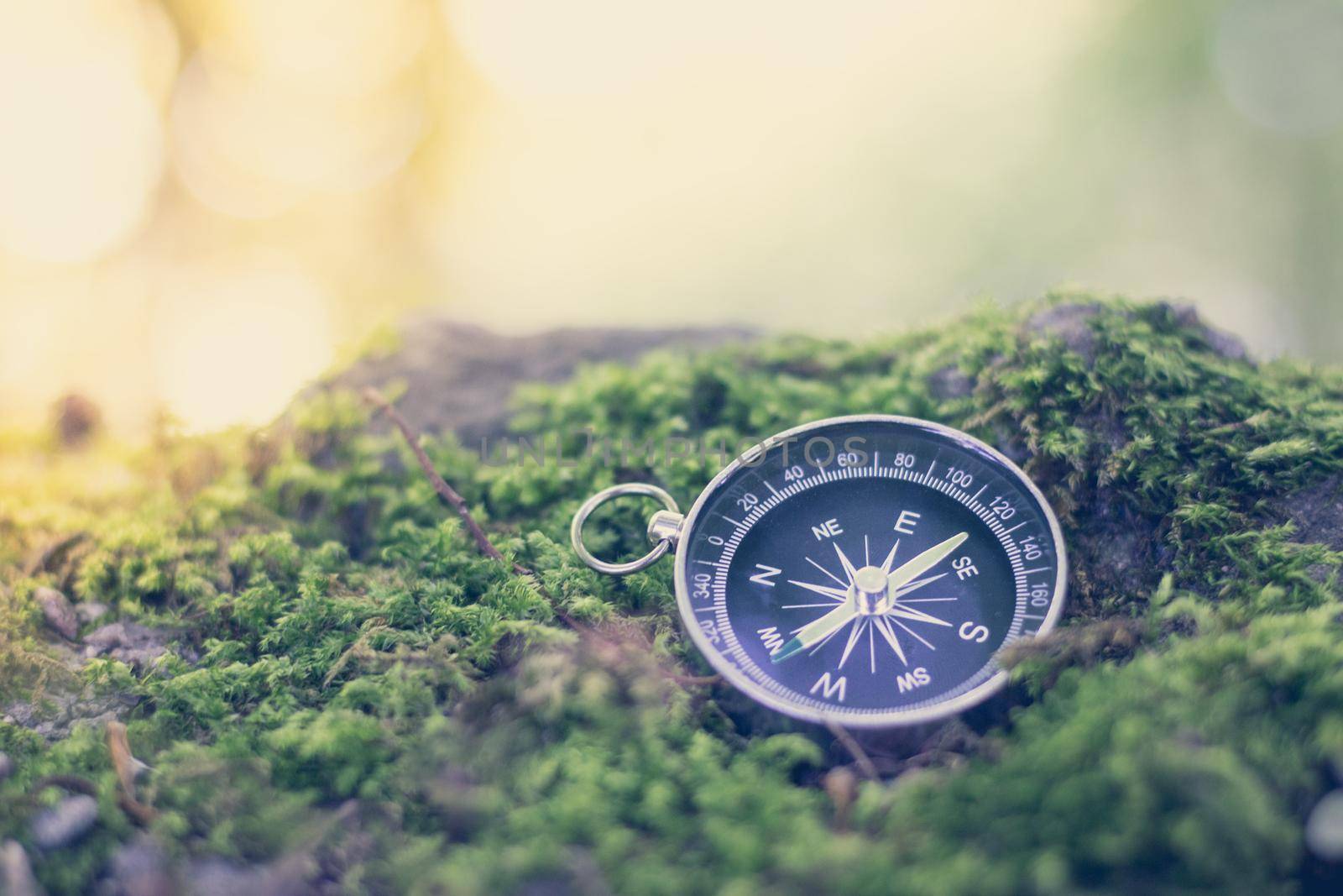 Vintage compass lying on the floor. Adventure and discovery concept.