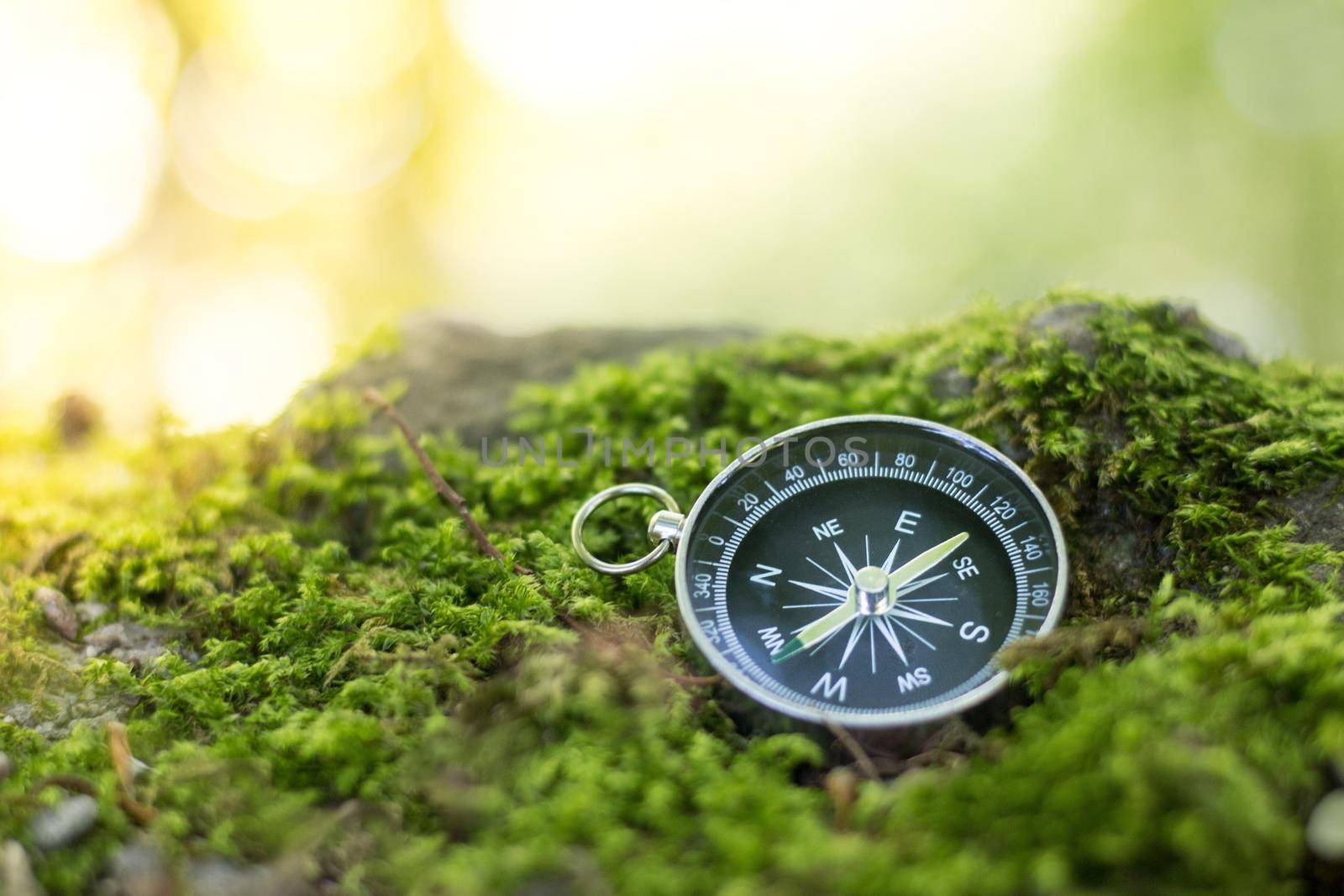 Vintage compass lying on the floor. Adventure and discovery concept.