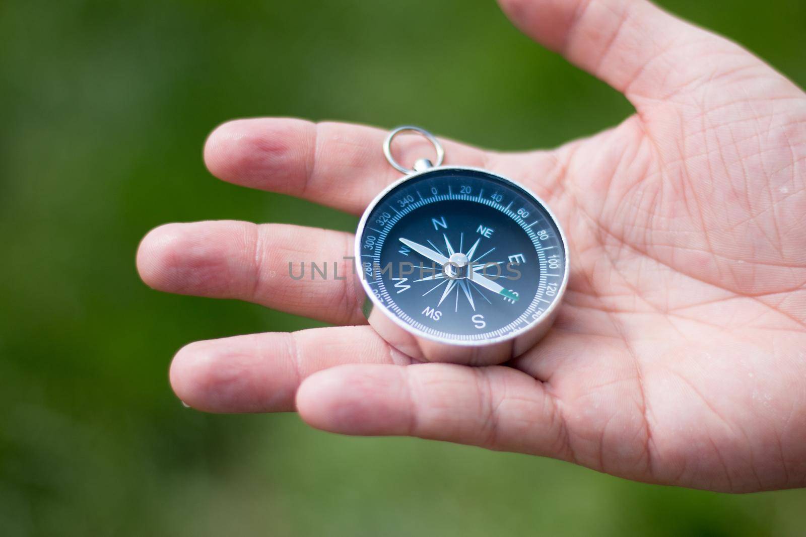Vintage compass in man’s hand, adventure and discovery concept