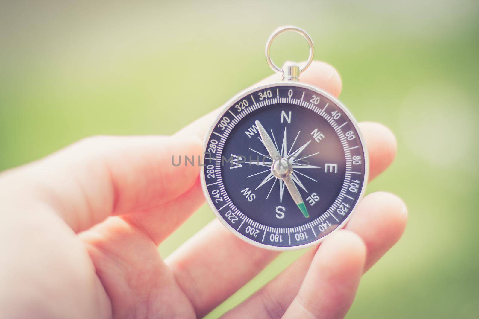 Vintage compass in man’s hand, adventure and discovery concept