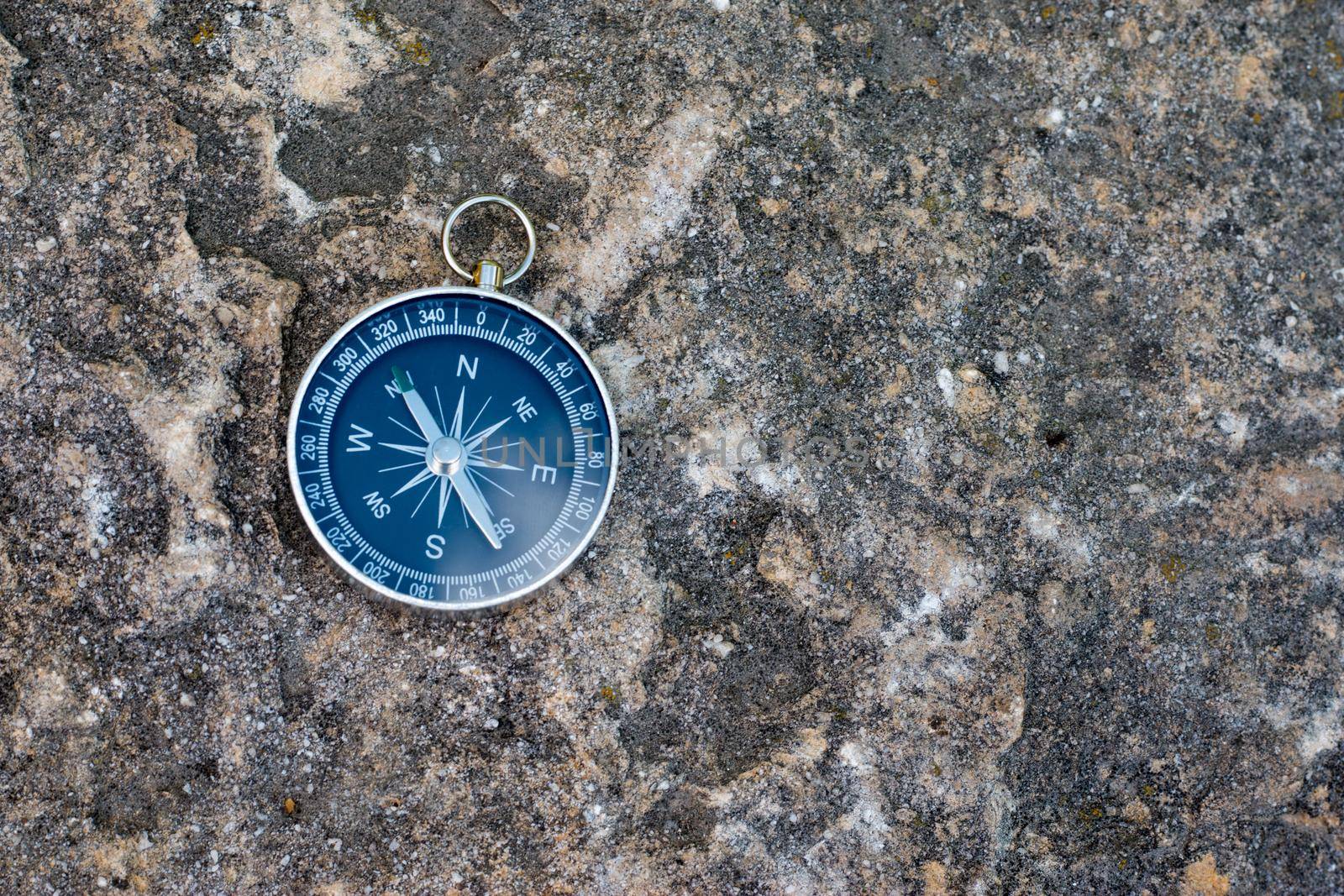 Vintage compass lying on the floor. Adventure and discovery concept.