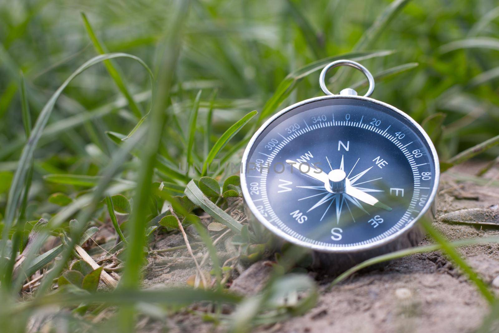 Vintage compass lying on the floor. Adventure and discovery concept.