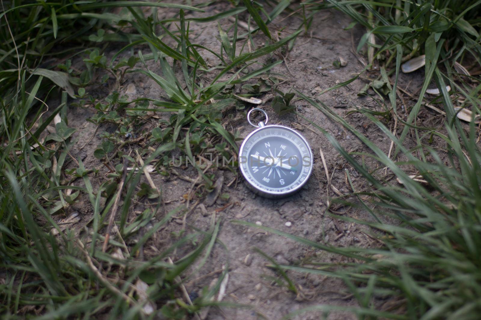 Vintage compass lying on the floor. Adventure and discovery concept.