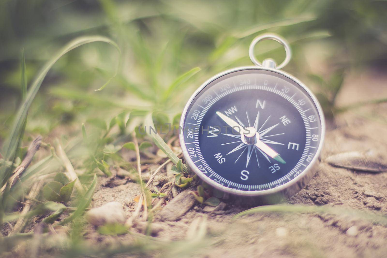 Vintage compass lying on the floor. Adventure and discovery concept.