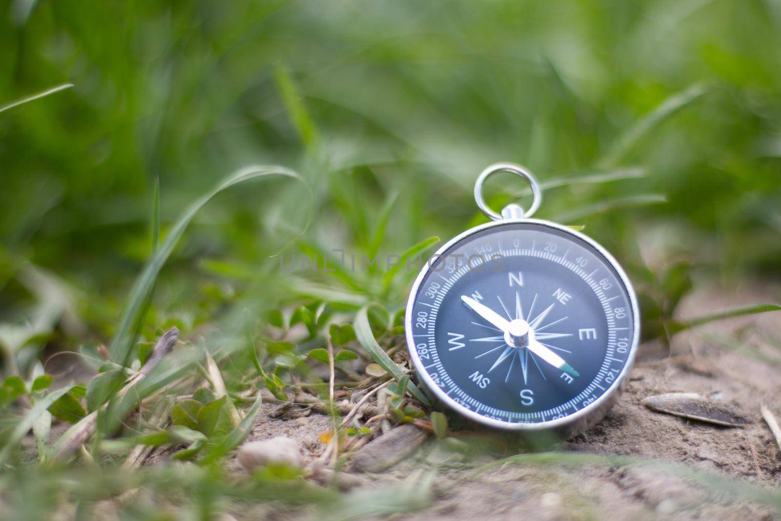 Vintage compass lying on the floor. Adventure and discovery concept.