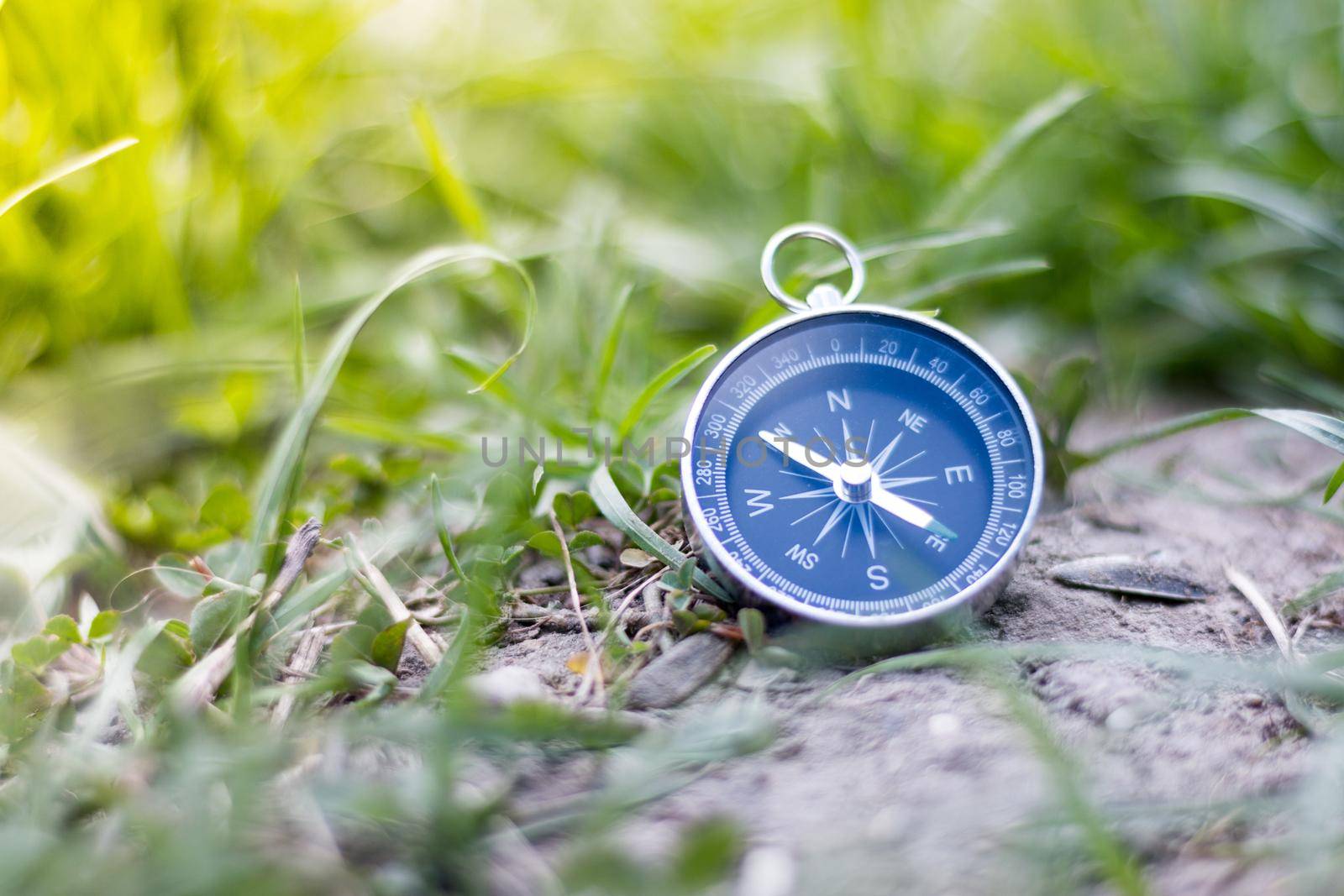 Vintage compass lying on the floor. Adventure and discovery concept.