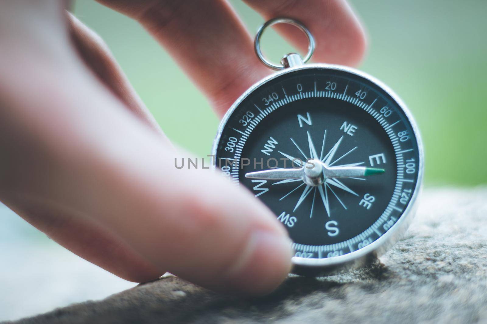 Vintage compass lying on the floor. Adventure and discovery concept.