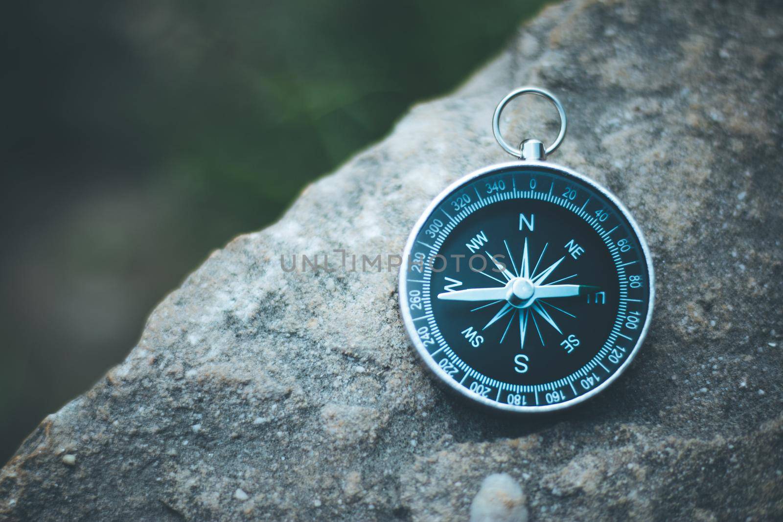 Vintage compass lying on the floor. Adventure and discovery concept.