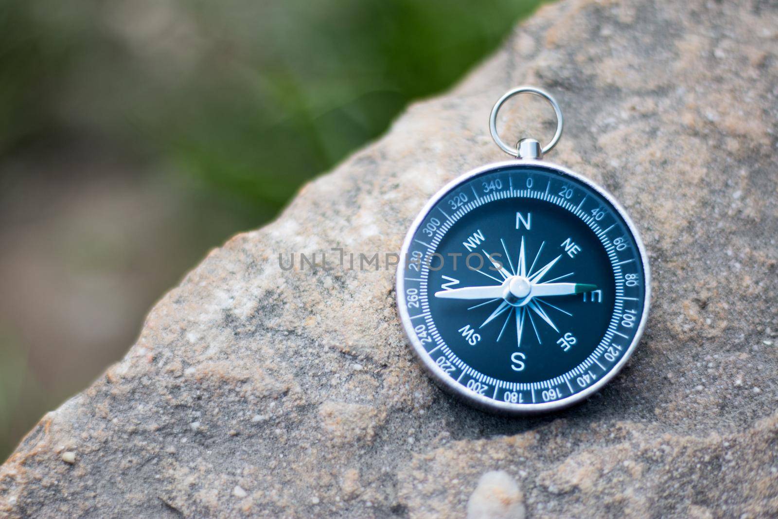 Vintage compass lying on the floor. Adventure and discovery concept.