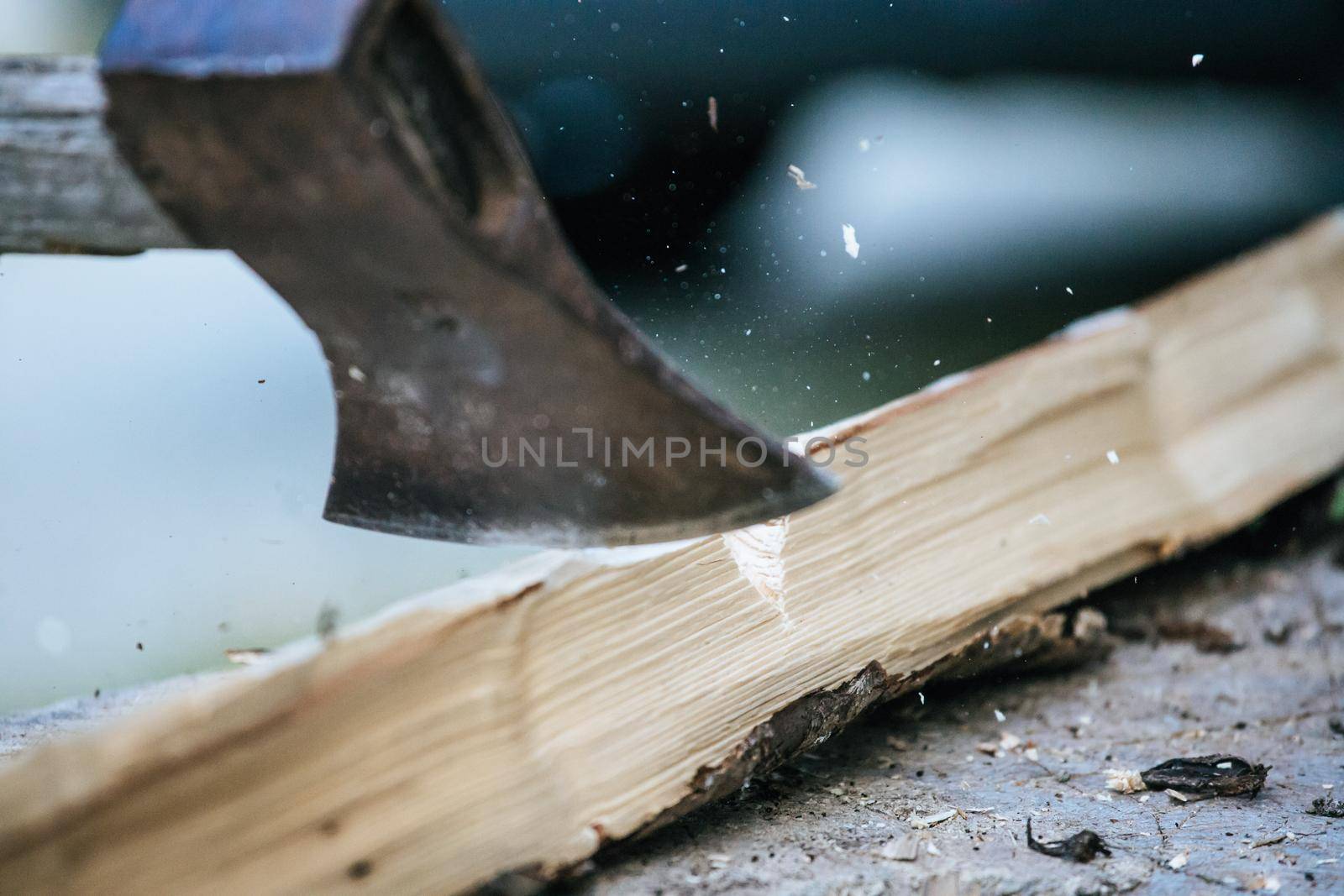 Sharpe axe is cutting wood for making fire, close up picture