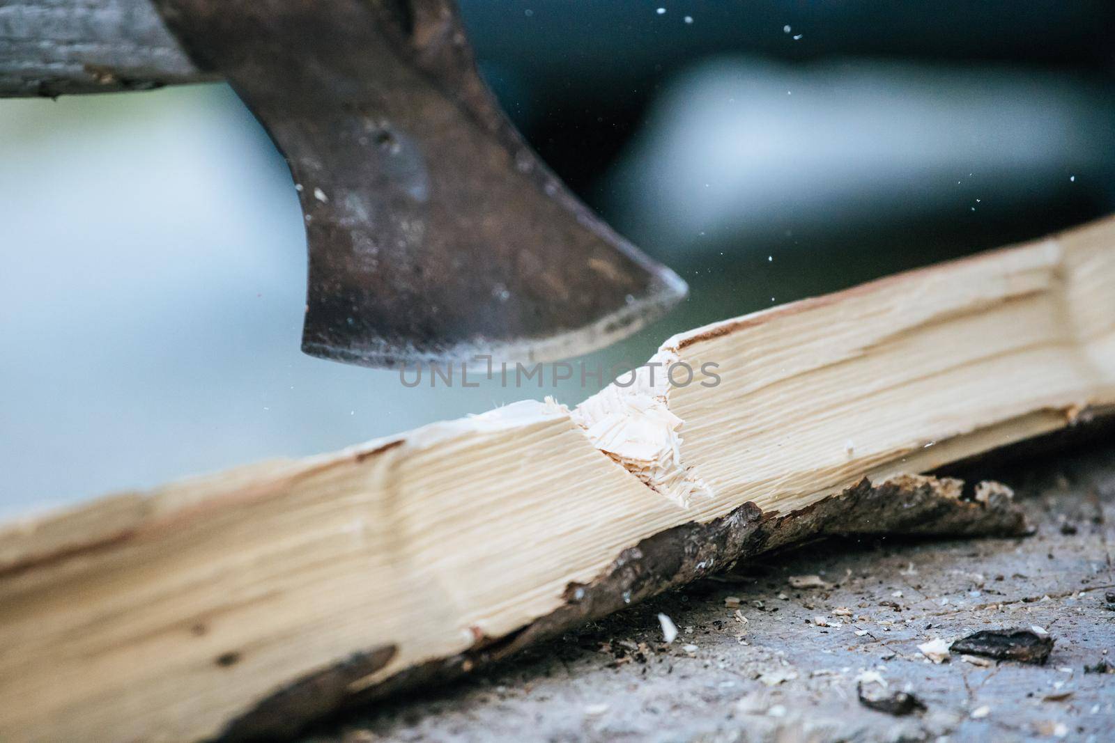Sharpe axe is cutting wood for making fire, close up picture