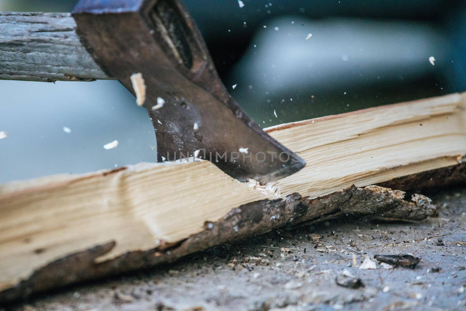 Sharpe axe is cutting wood for making fire, close up picture