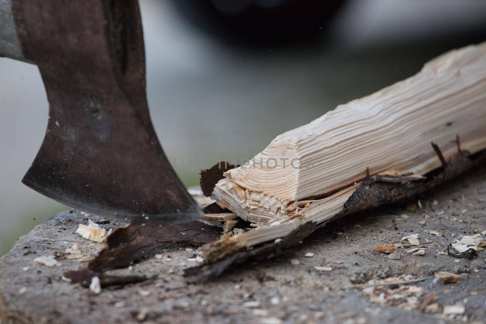 Sharpe axe is cutting wood for making fire, close up picture