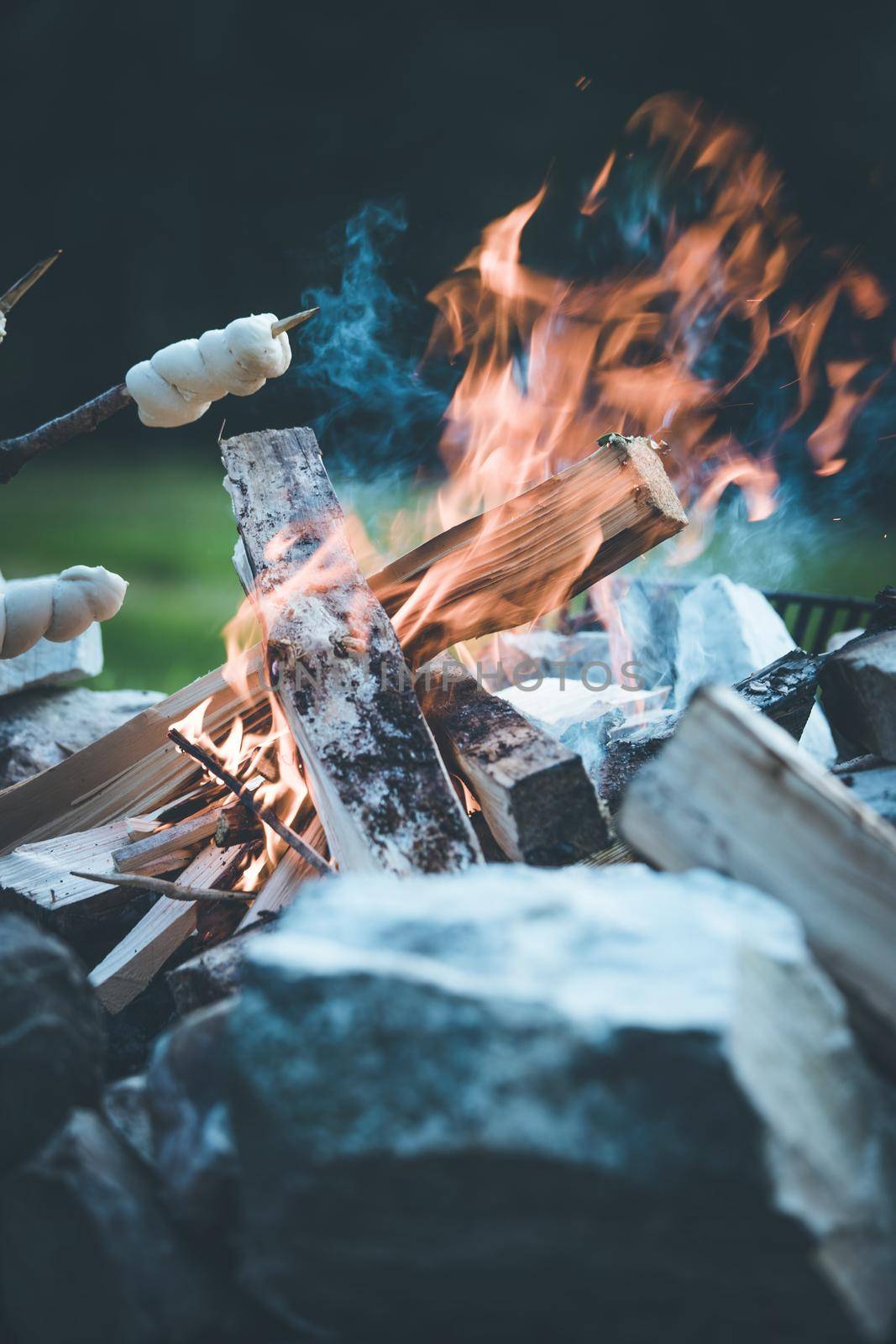 Having a barbecue on the bonfire, outdoors. Baking bread.