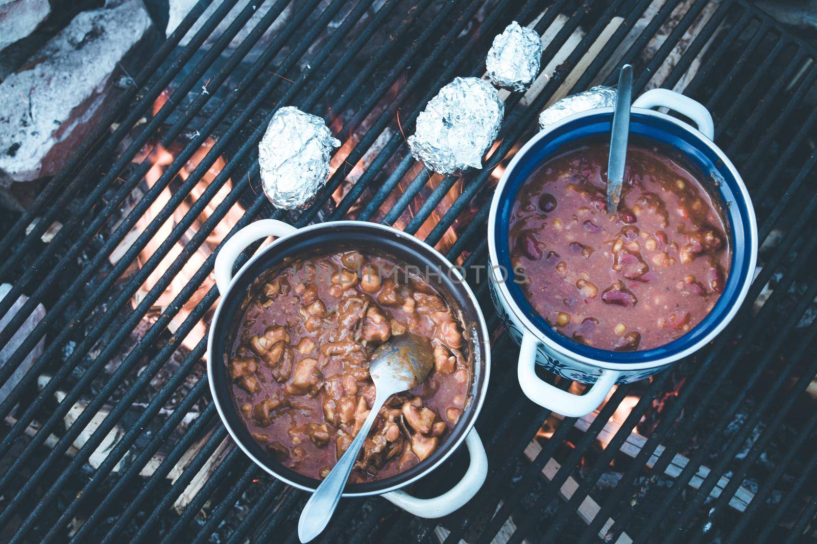 Tasty and spicy stew on bonfire, outdoors on a camping trip