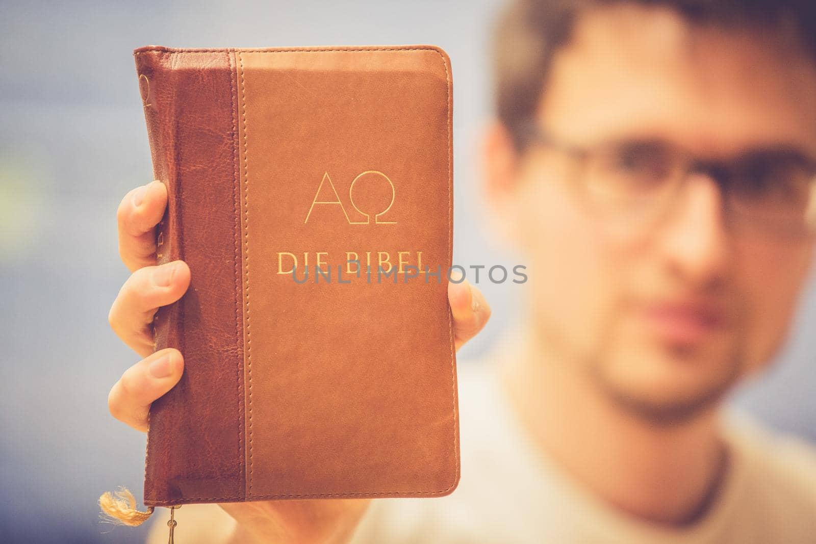 Young preacher is holding the holy bible, praying
