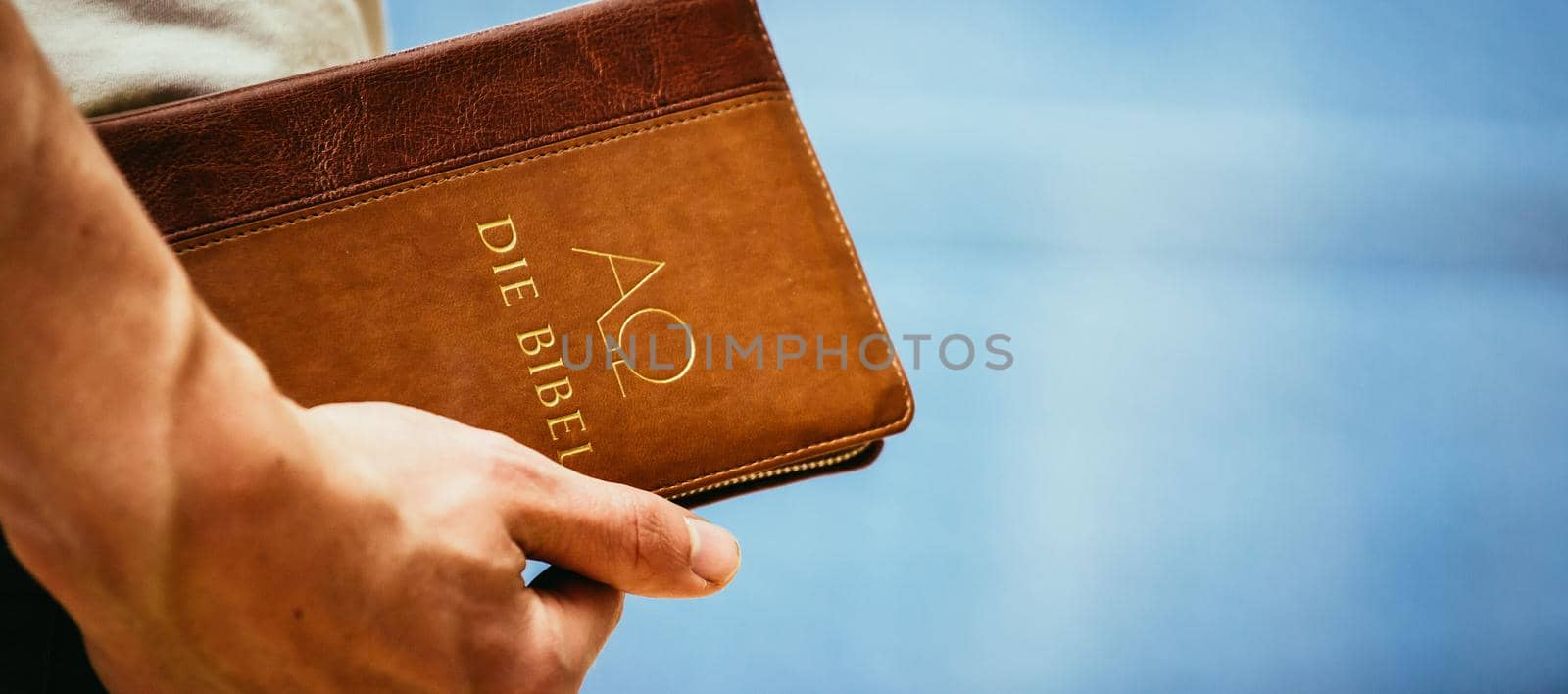 Young preacher is holding the holy bible, praying