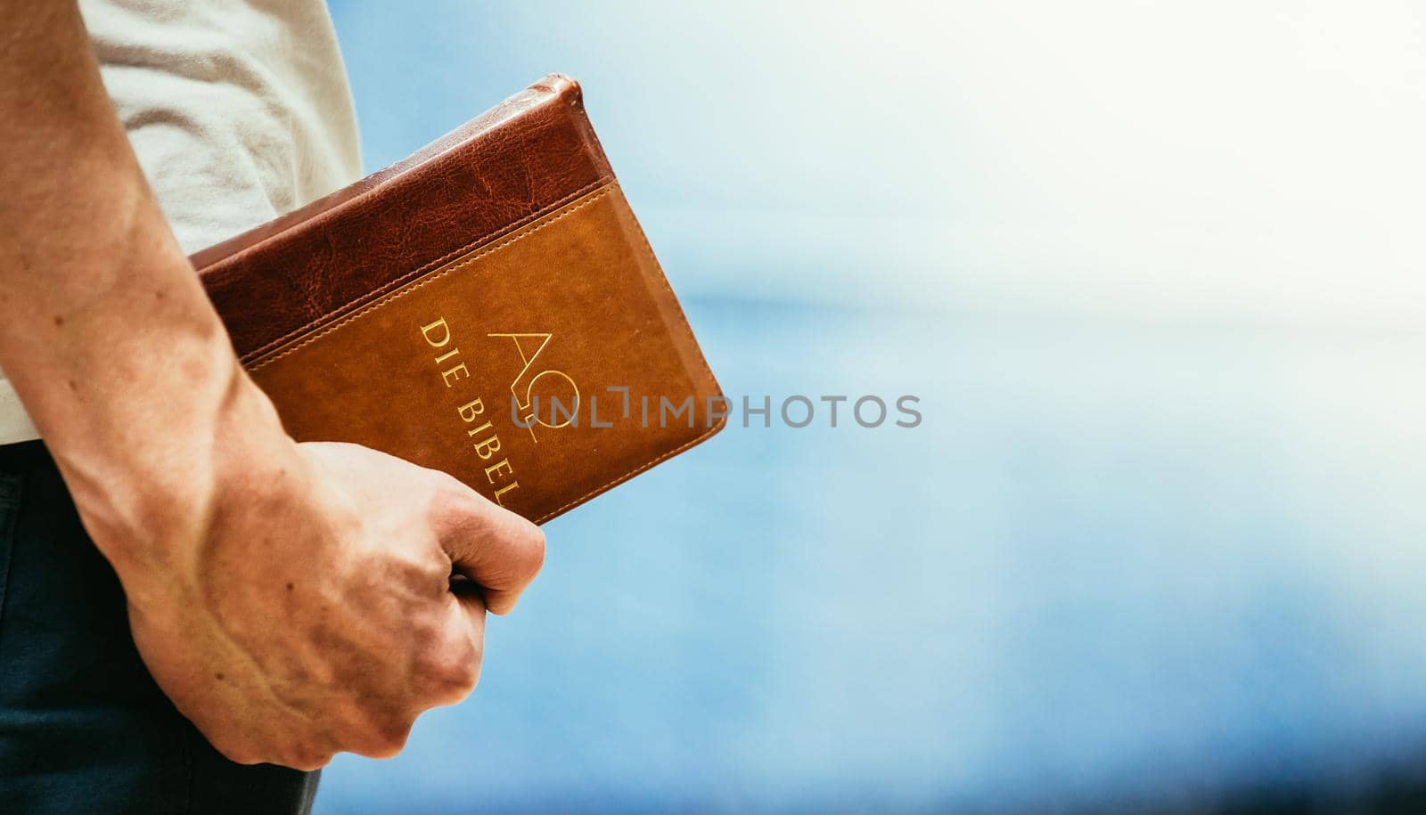 Young preacher is holding the holy bible, praying