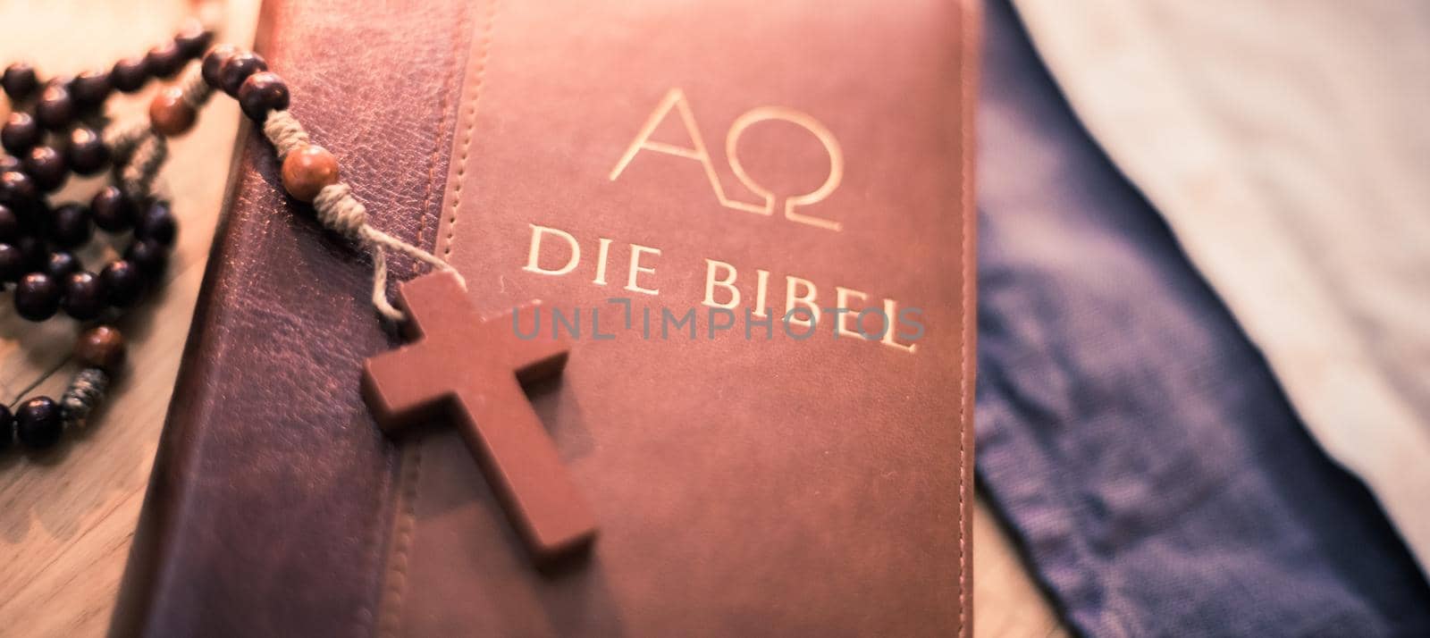 Holy bible and rosary: Christian bible and rosary on a wooden desk by Daxenbichler