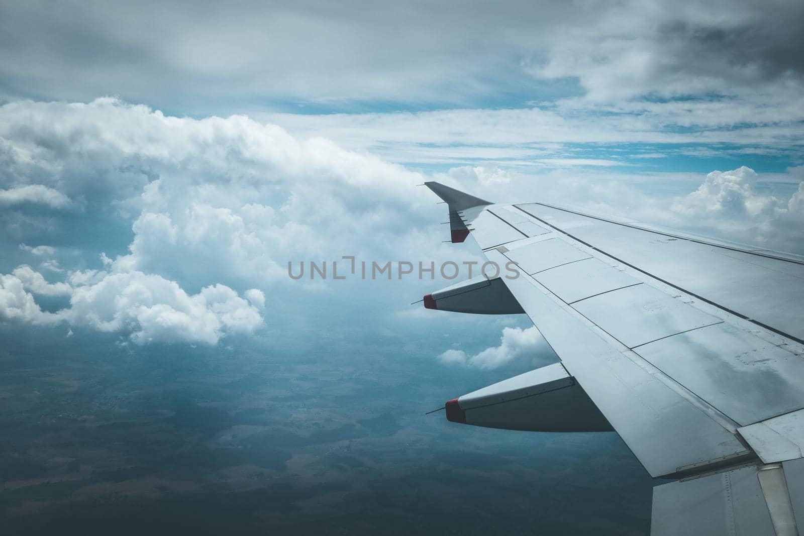 View of a grey airplane wing through the aircraft window. Global warming.