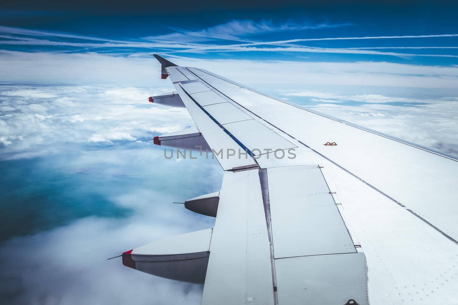 View of a grey airplane wing through the aircraft window. Global warming.