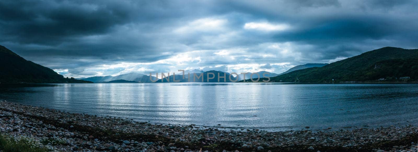 Mystic landscape lake scenery in Scotland: Cloudy sky, sunbeams and mountain range in loch Linnhe by Daxenbichler