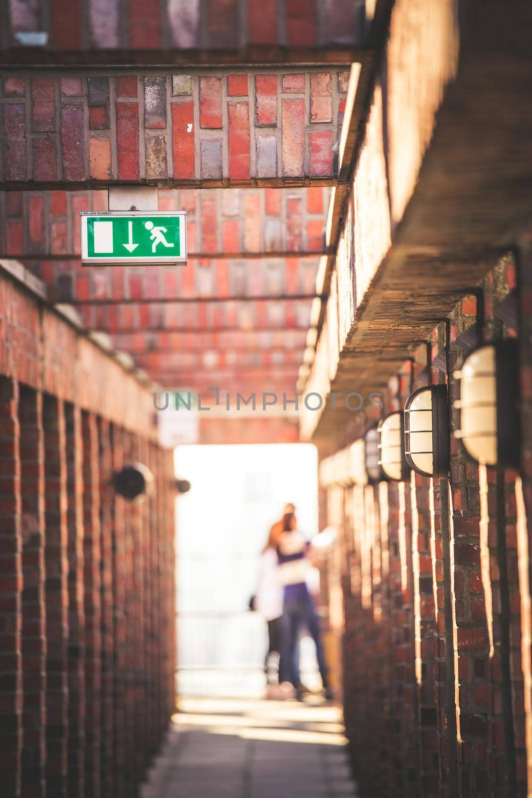 Lamps on a masoned building, blurry background with people