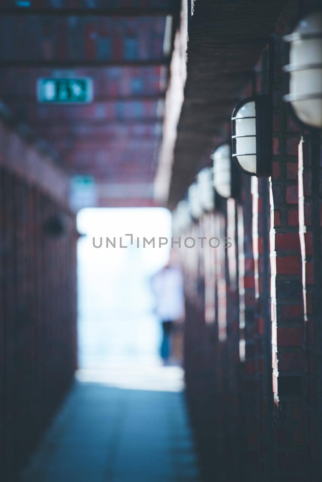 Lamps on a masoned building, blurry background with people