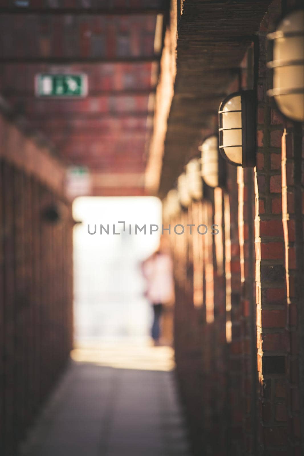 Lamps on a masoned building, blurry background with people