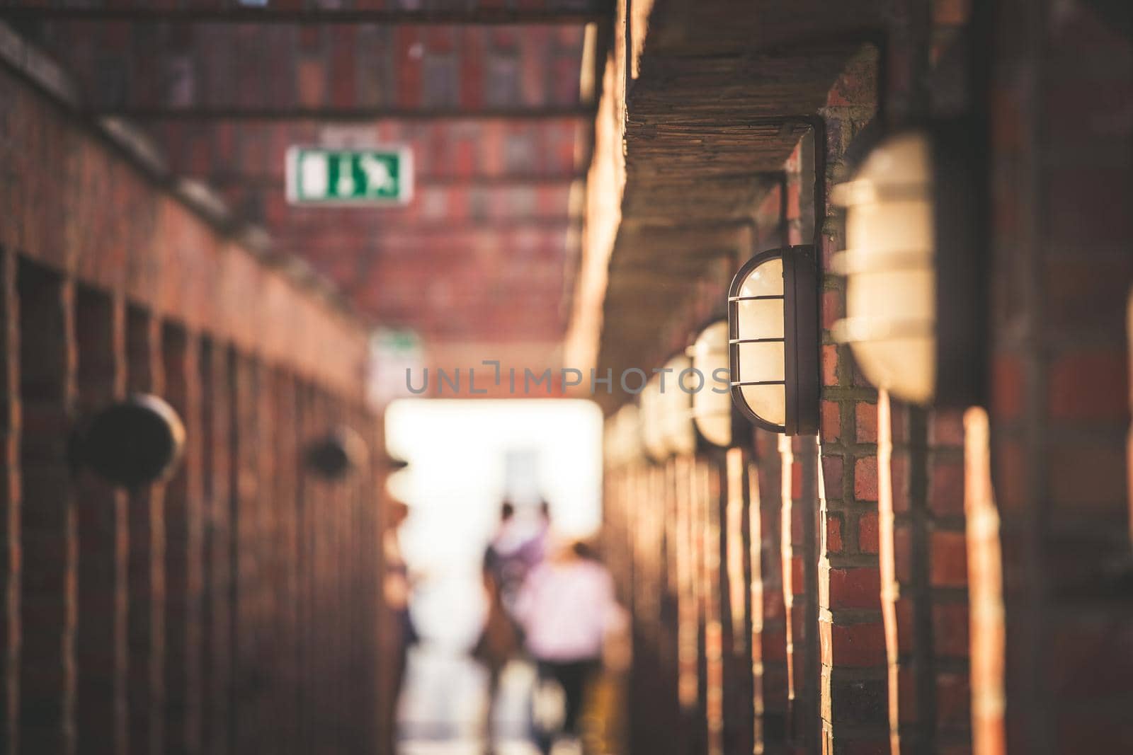 Lamps on a masoned building, blurry background with people