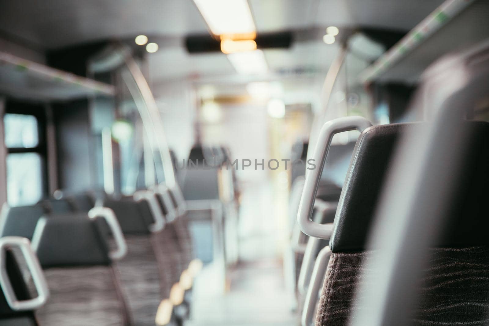 Interior of a public transport train, empty seats by Daxenbichler