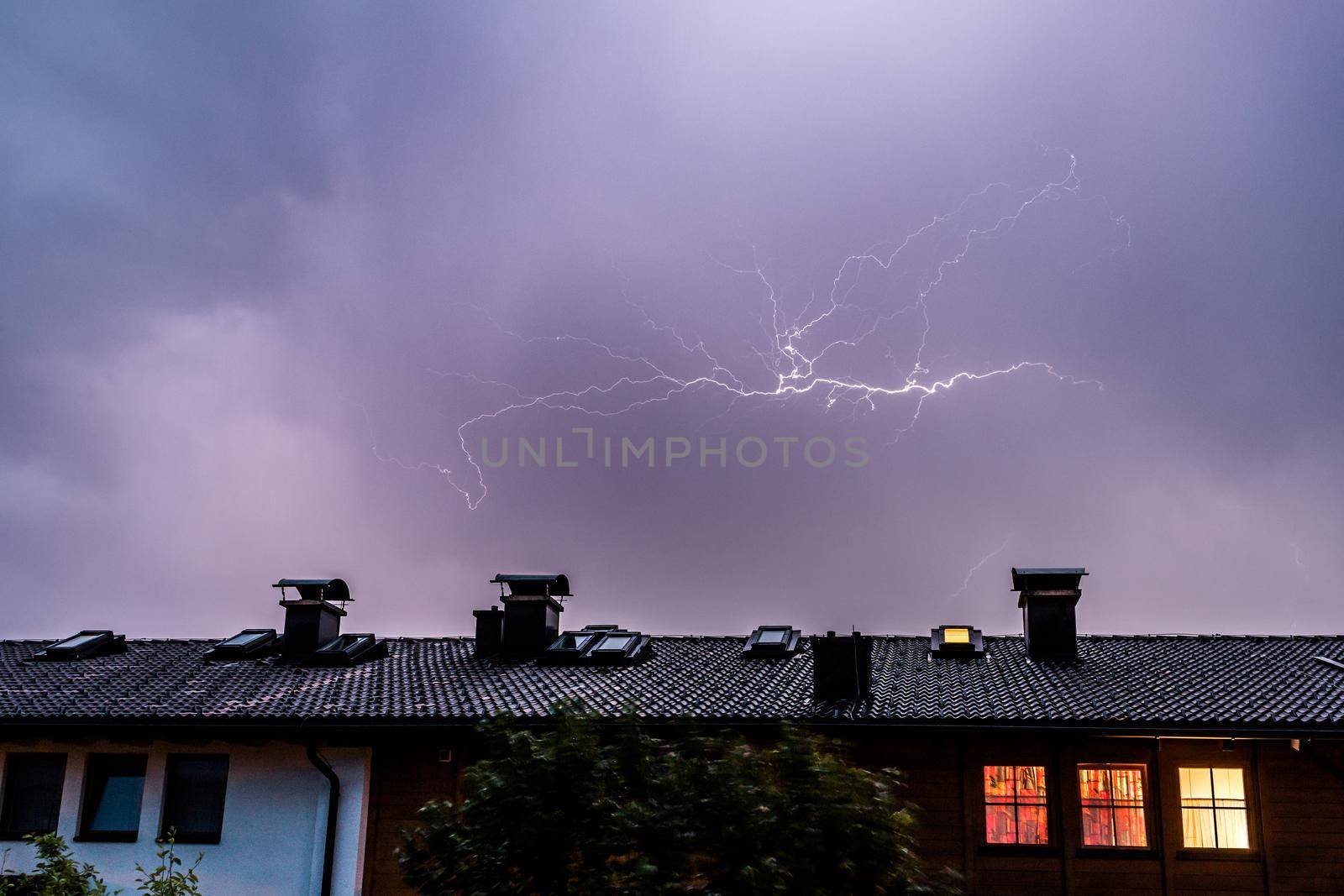Lightning on the colored sky, roof of a building