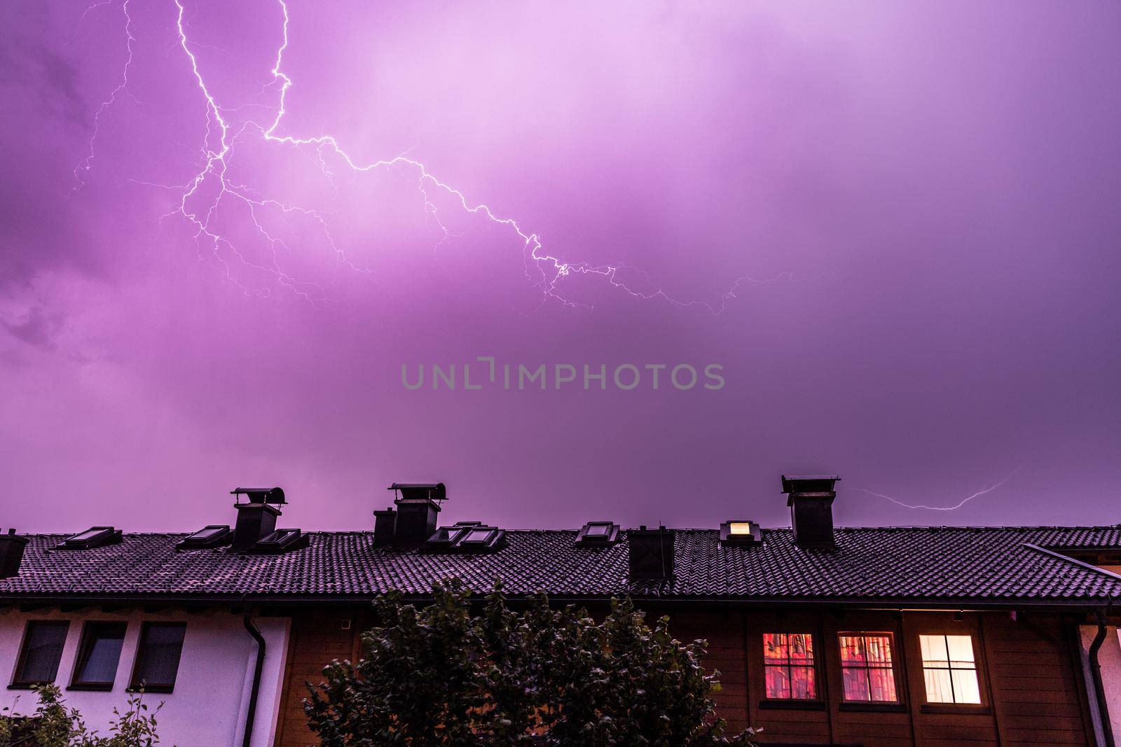 Lightning on the colored sky, roof of a building