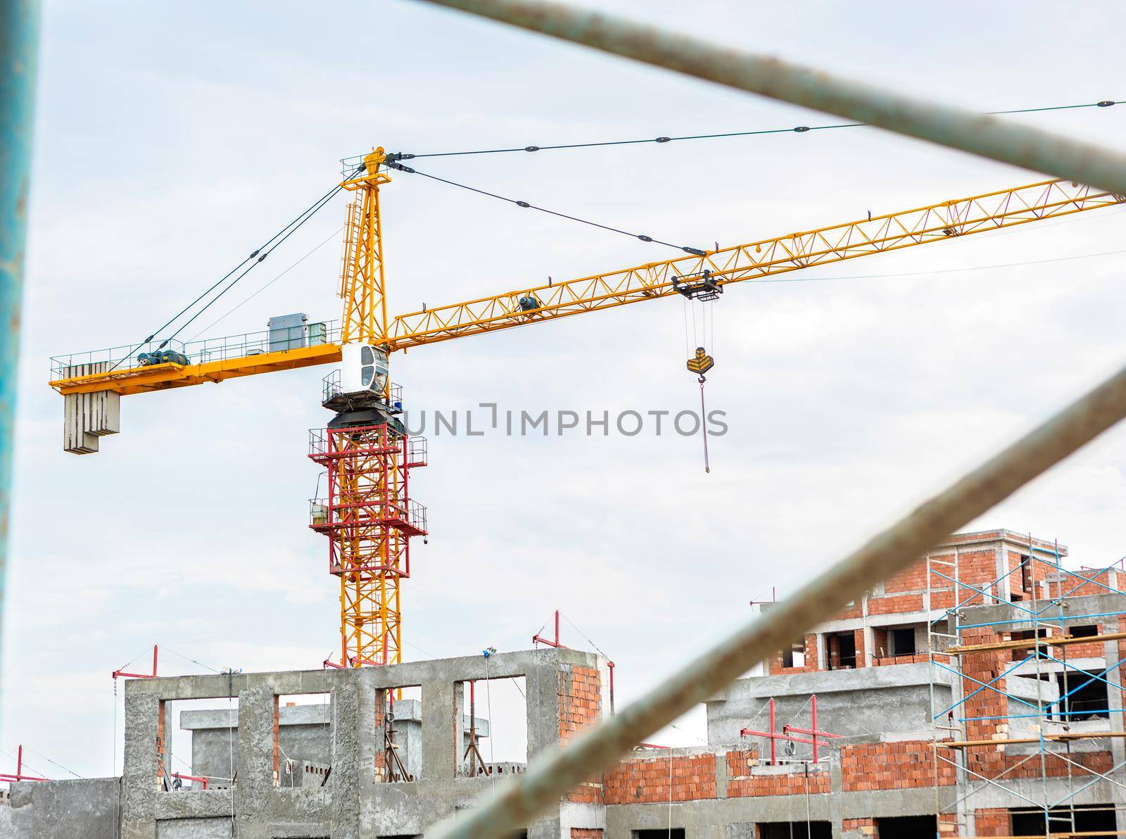 Crane with high buildings scaffold at the construction site, top view by ferhad