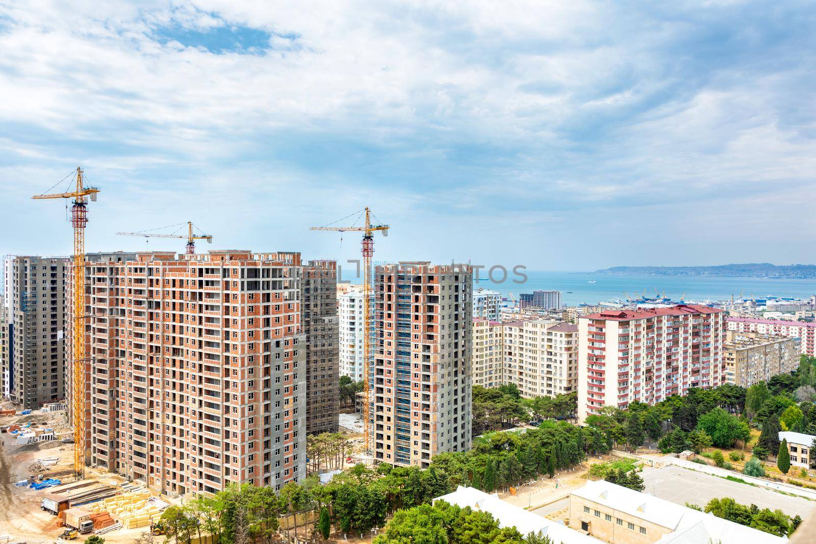 High buildings scaffold at the construction site, city view by ferhad