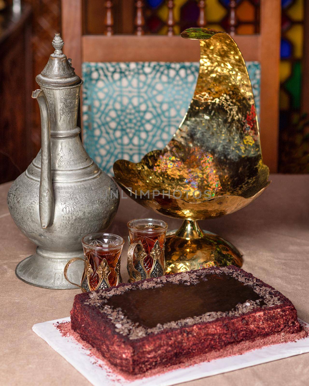 Arabic teapot glass and cake close up