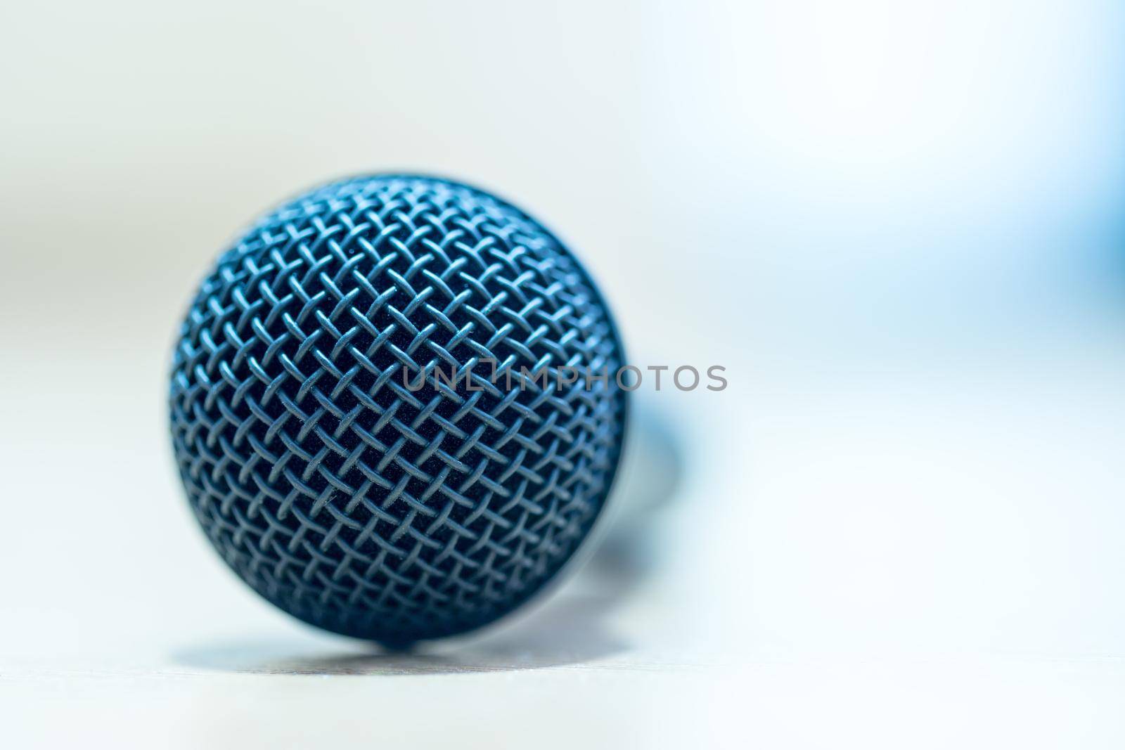 Black microphone stands on the desk. Interview, copy space.