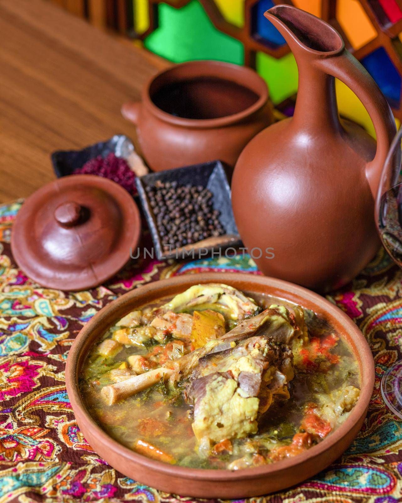 Beef meat soup with a wine bottle