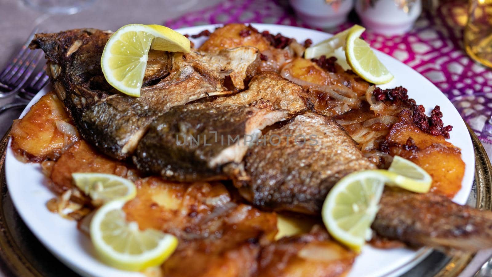 Grilled whole fish with a lemon close up by ferhad