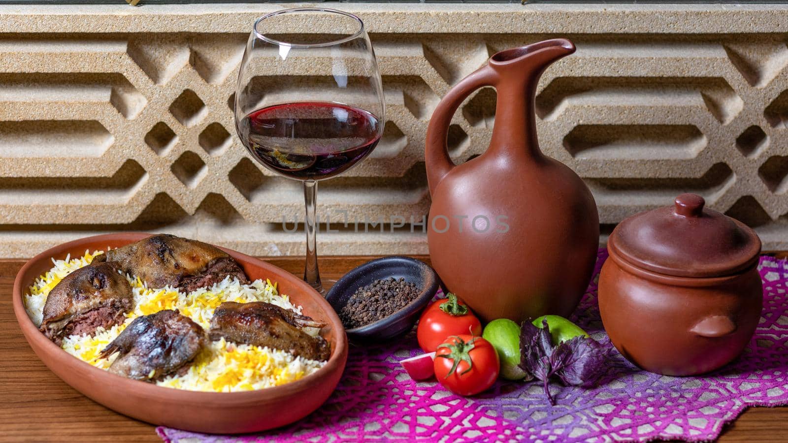 Grilled coot on the rice with red wine glass