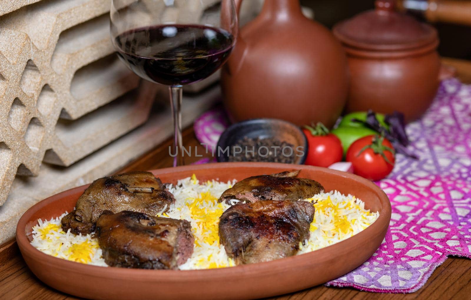 Grilled coot on the rice with red wine glass