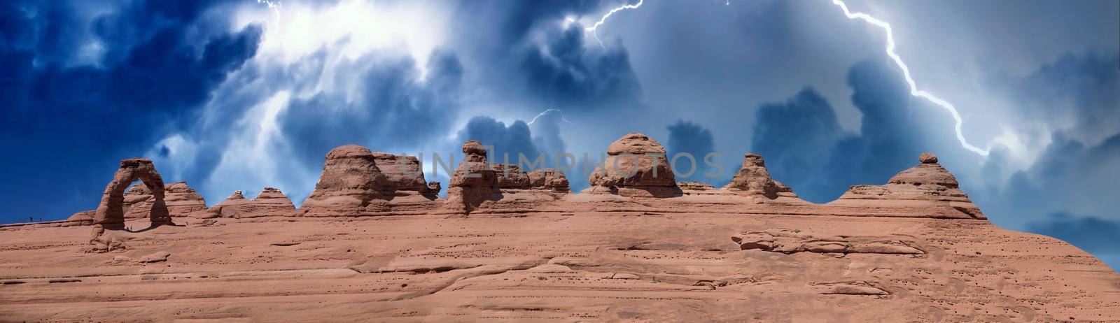 Delicate Arch panoramic view, Arches National Park. High resolution image of rock formations during a storm by jovannig