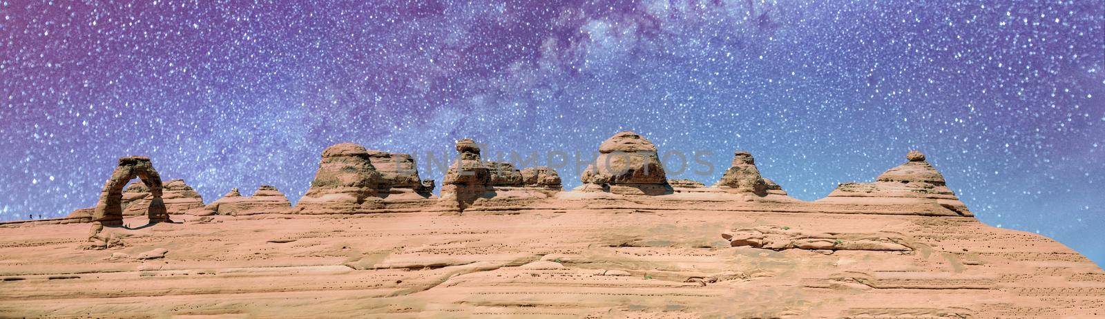 Delicate Arch panoramic view, Arches National Park. High resolution image of rock formations on a starry night by jovannig