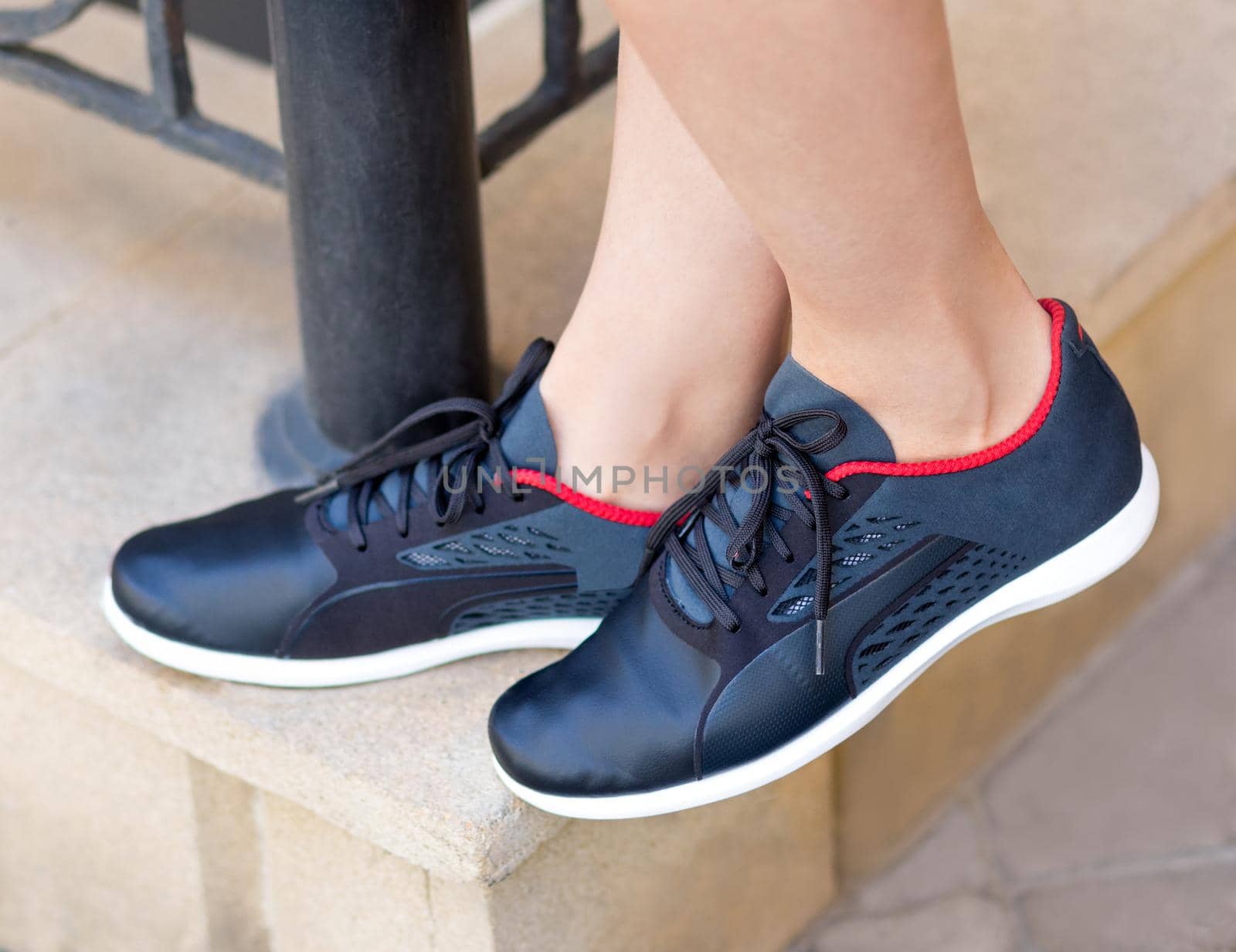 Woman with a blue running shoes close up