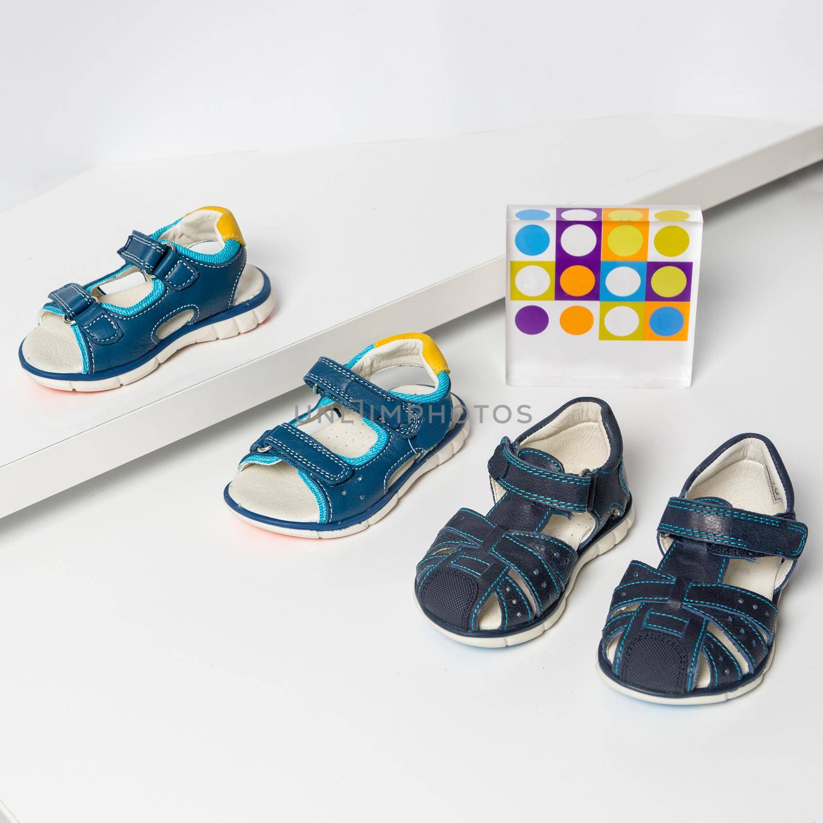 Blue kids sandals on a white background