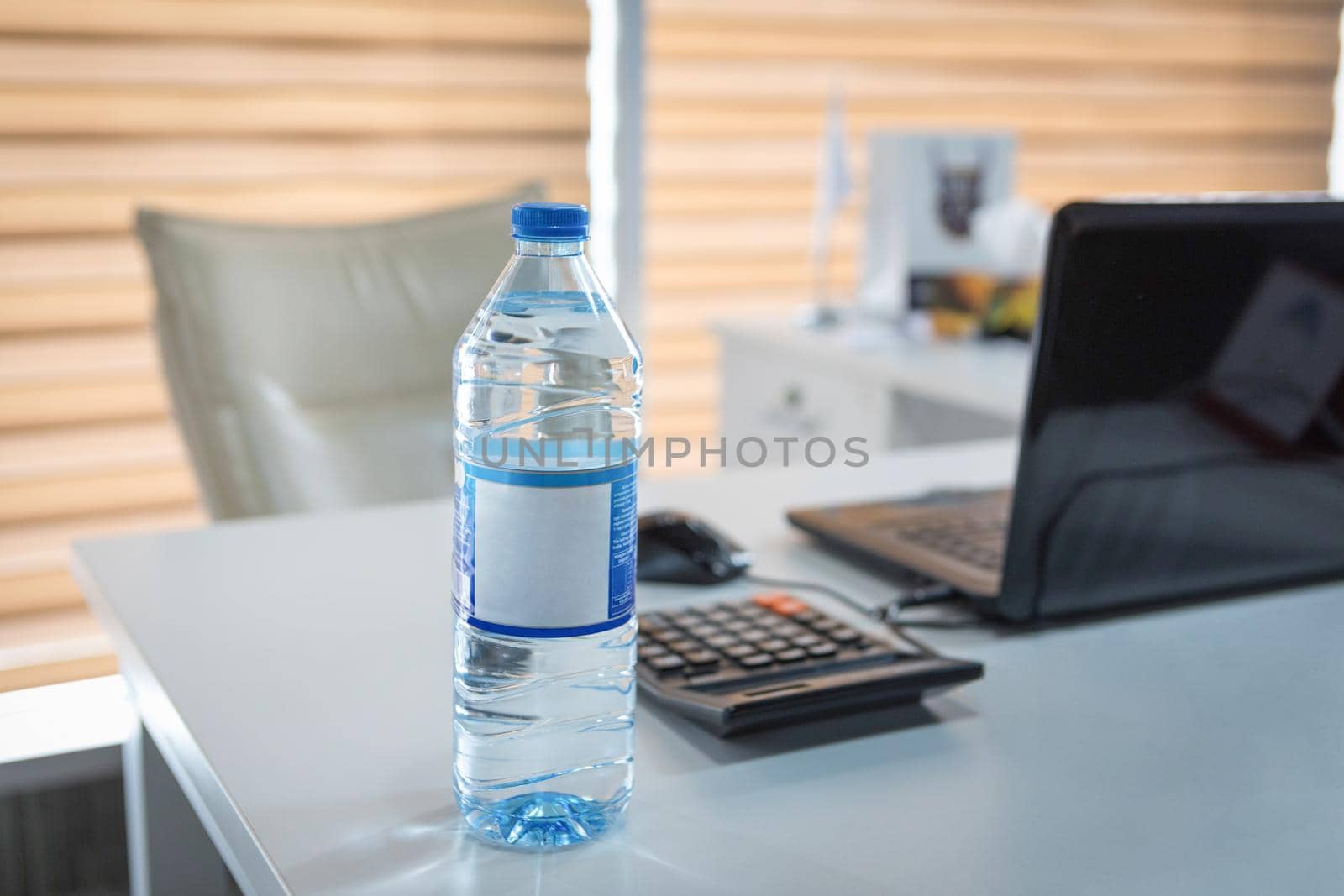 Plastic water bottle on the office desk by ferhad