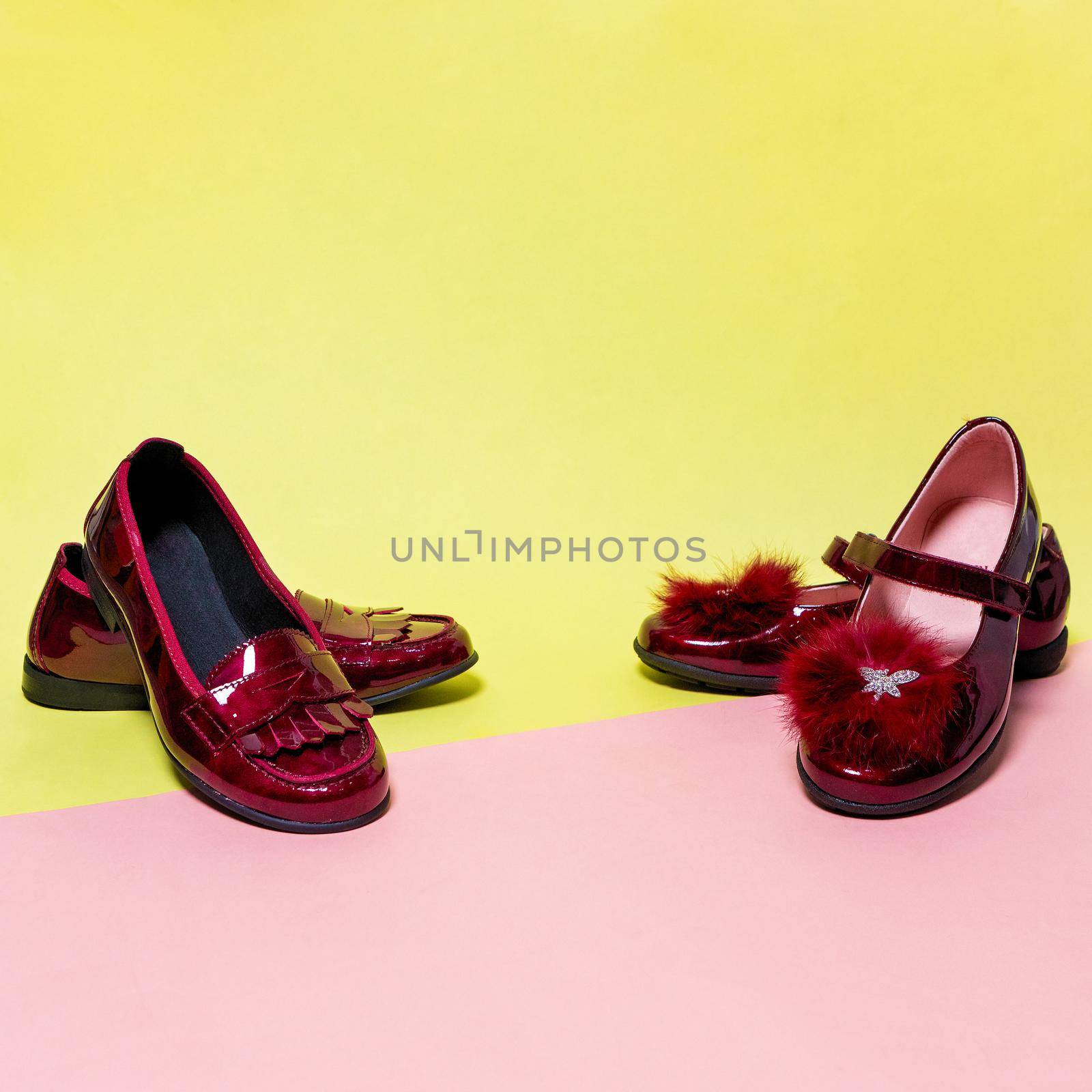Red shiny girl shoes isolated on a colorful background by ferhad
